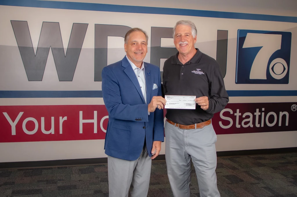 WDBJ-7 General Manager and Vice President Matt Pumo (at left) shares the check for the Robin Reed Journalism Scholarship with Professor of Practice Robin Reed.